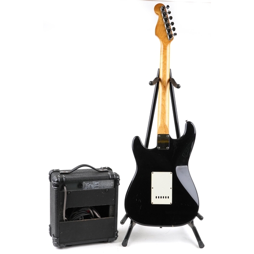 453 - An Encore Stratocaster six string electric guitar together with a 'The Animal' practice' amplifier.