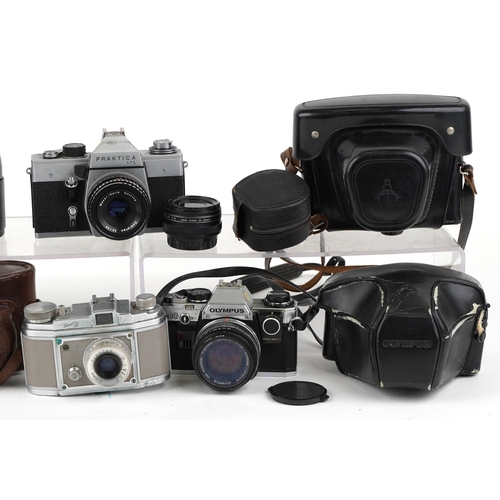 487 - Vintage and later cameras and lenses including Finetta 88, Olympus OM10 and Prakitica.