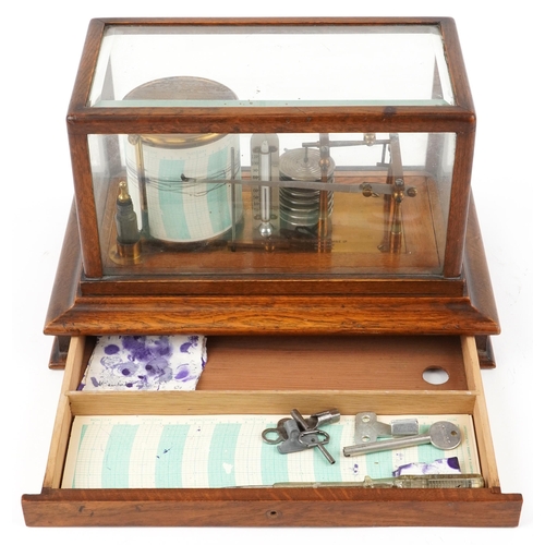 310 - An early 20th century oak cased barograph bearing retailer's label M. W. Dunscombe Ltd. Opticians Br... 