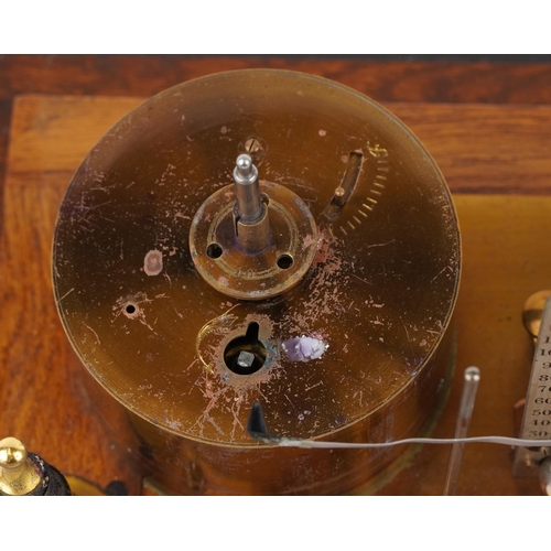 310 - An early 20th century oak cased barograph bearing retailer's label M. W. Dunscombe Ltd. Opticians Br... 