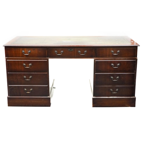 1028 - A late 20th century mahogany twin pedestal desk, the top inset with green leather writing surface ab... 