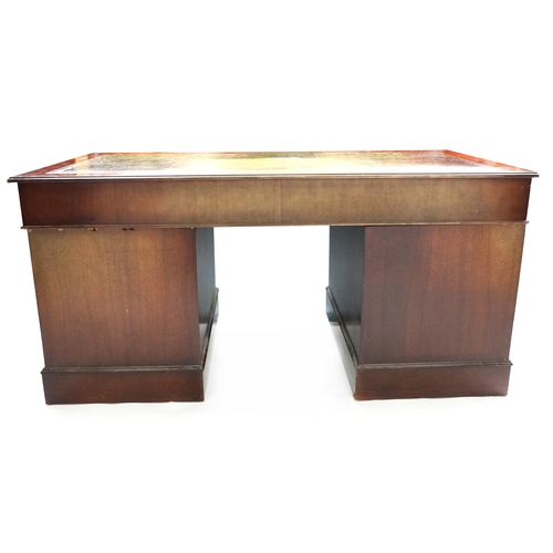 1028 - A late 20th century mahogany twin pedestal desk, the top inset with green leather writing surface ab... 