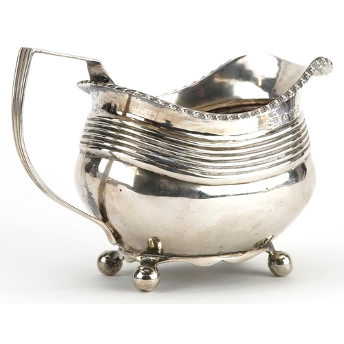 652 - William Hunter II, George IV silver cream jug raised on four ball feet, London 1820, 13.5cm in lengt... 