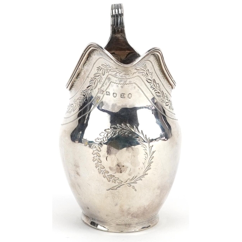 667 - A George III silver cream jug engraved with foliage, London 1799, 10.5cm high, 94.0g.