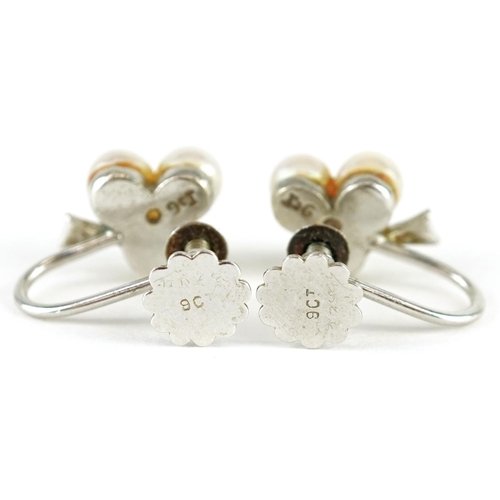 137 - A pair of 9ct white gold cultured pearl earrings with screw backs, 1.5cm high, total 2.5g.