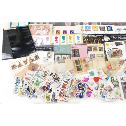 1528 - A quantity of British stamps to include mainly presentation packs and many loose postage stamps, fir... 