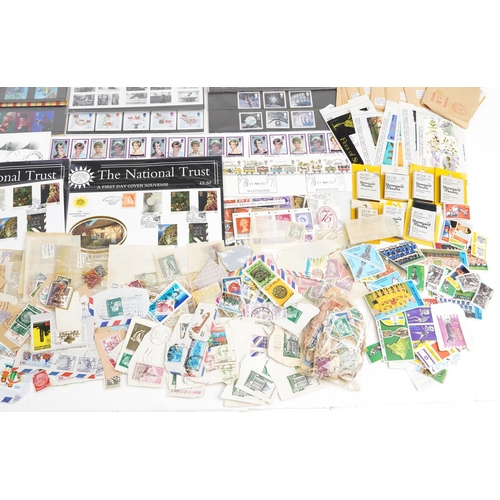 1528 - A quantity of British stamps to include mainly presentation packs and many loose postage stamps, fir... 