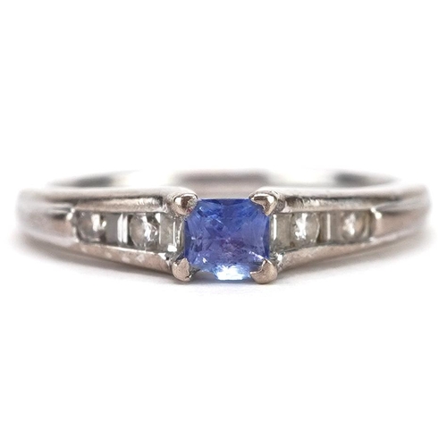 89 - An 18ct white gold tanzanite solitaire ring with diamond set shoulders, size N, 3.5g.