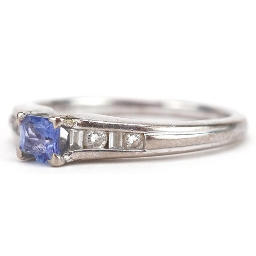 89 - An 18ct white gold tanzanite solitaire ring with diamond set shoulders, size N, 3.5g.