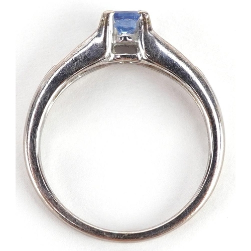 89 - An 18ct white gold tanzanite solitaire ring with diamond set shoulders, size N, 3.5g.