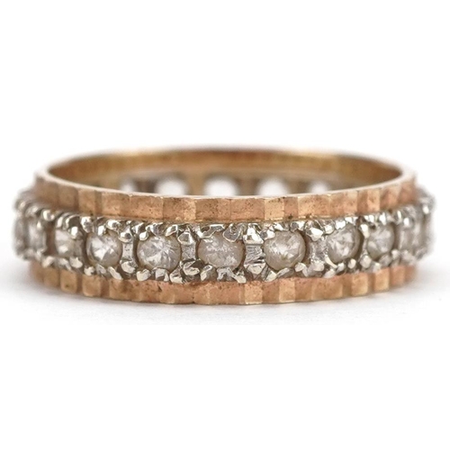 202 - A 9ct two tone gold white spinel eternity ring, size P, 3.6g.