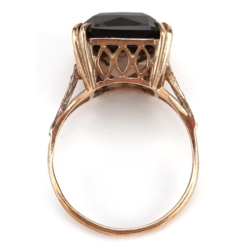 306 - A 9ct gold rectangular cut smoky quartz ring with pierced setting and engraved shoulders, size P, 4.... 