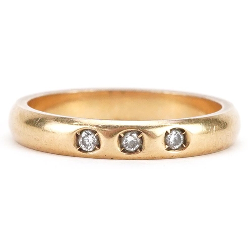 74 - An 18ct gold diamond three stone ring, size O, 4.5g.