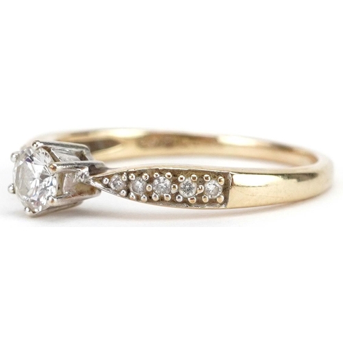 10 - A 9ct gold diamond solitaire ring with diamond set shoulders, total diamond weight approximately 0.3... 