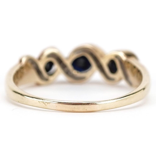 380 - An unmarked gold sapphire and diamond crossover ring, size Q/R, 3.0g.