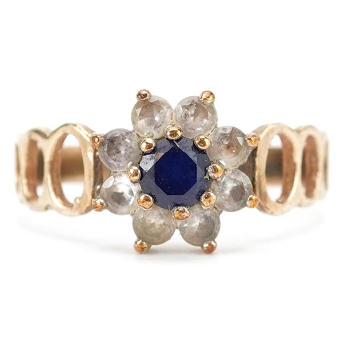 390 - A 9ct gold sapphire and clear stone flower head ring with pierced shoulders, size M/N, 2.2g.