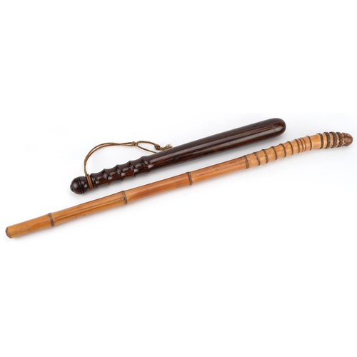 132 - A 20th century turned walnut truncheon, 40cm in length, together with a bamboo throwing stick, 62cm ... 