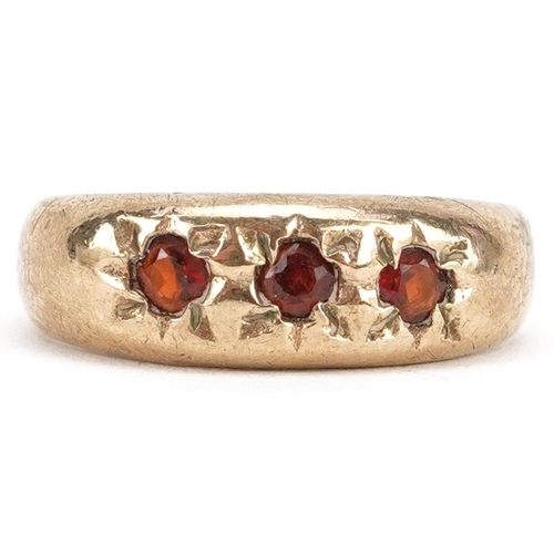 2349 - A broken 9ct gold garnet three stone Gypsy ring, size F/G, 1.8g.