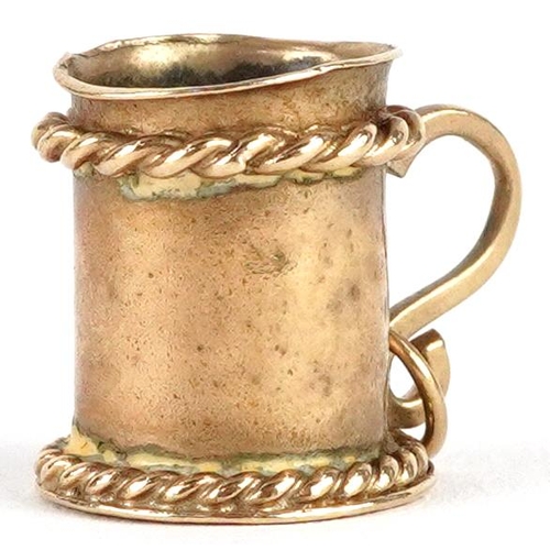 2393 - A 9ct gold charm in the form of a tankard, 1.3cm high, 2.4g.