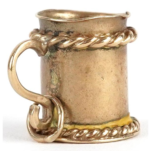 2393 - A 9ct gold charm in the form of a tankard, 1.3cm high, 2.4g.