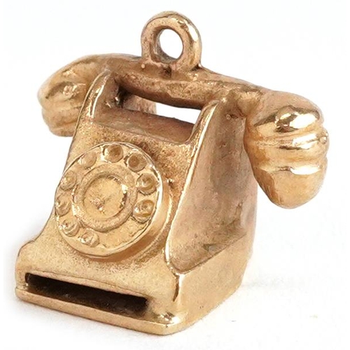 2357 - A 9ct gold charm in the form of a vintage dial telephone, 1.3cm wide, 2.4g.