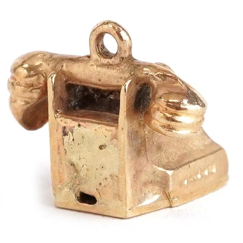 2357 - A 9ct gold charm in the form of a vintage dial telephone, 1.3cm wide, 2.4g.