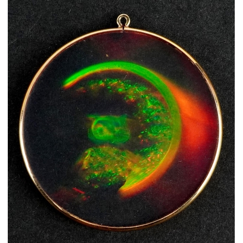 2144 - A holographic owl and moon pendant with yellow metal mount, 3.8cm in diameter.