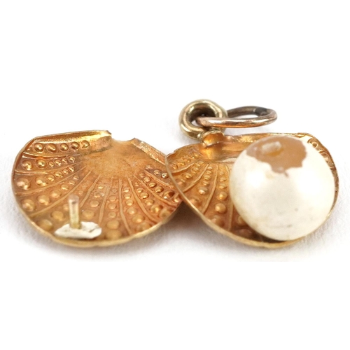 2499 - Three 9ct gold charms including a crystal globe, the largest 2.2cm in length, total weight 3.5g.