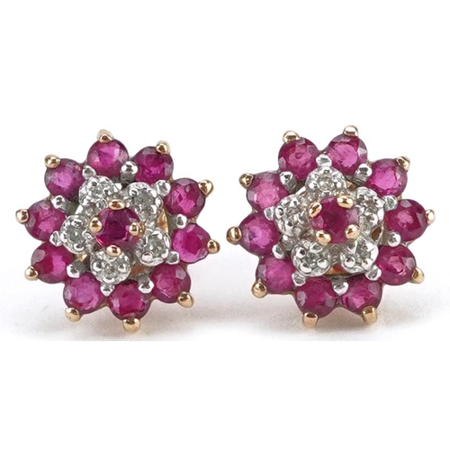 2291 - A pair of 9ct gold diamond and ruby three tier flower head earrings, 10.5mm in diameter, total 2.2g.