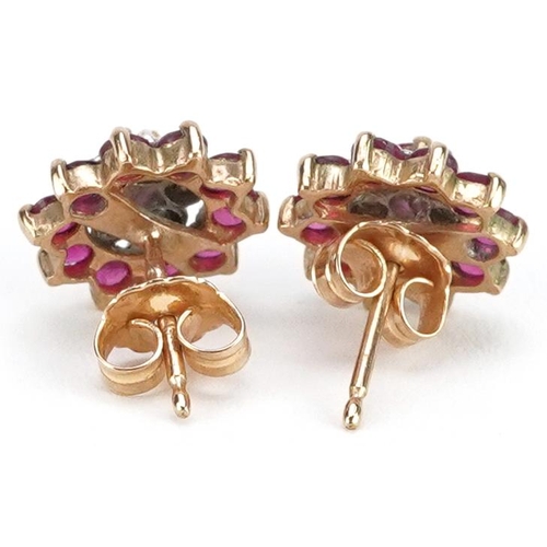 2291 - A pair of 9ct gold diamond and ruby three tier flower head earrings, 10.5mm in diameter, total 2.2g.