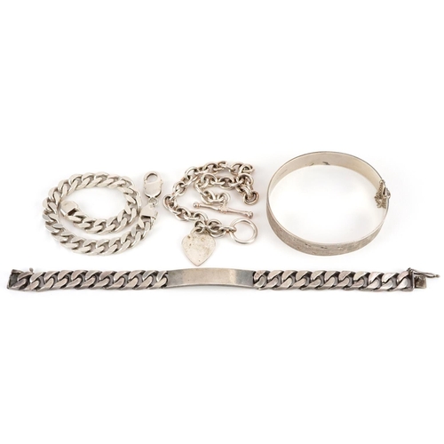 2542 - Four silver bracelets including a heavy unengraved identity bracelet and a Tiffany design love heart... 