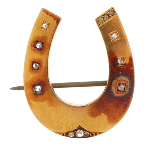 2016 - A Victorian unmarked gold horseshoe brooch set with diamonds, tests as 15ct gold, 2.7cm high, 5.7g.