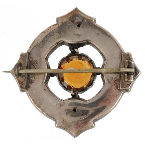 2329 - A Scottish unmarked silver and enamel kilt brooch set with a citrine solitaire, 4cm high, 9.8g.