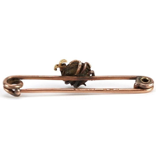 2386 - A 9ct rose gold enamel brooch in the form of a ladybird set with a diamond, 4.5cm wide, 4.0g.