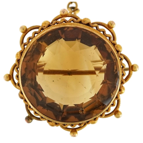 An unmarked gold citrine solitaire brooch, the citrine approximately 21mm in diameter x 14mm deep, total weight 13.0g.