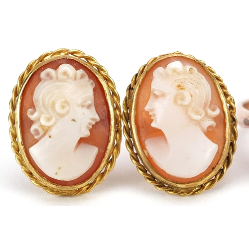 2334 - An unmarked gold cameo shell ring carved with a maiden head and pair of yellow metal cameo earrings,... 