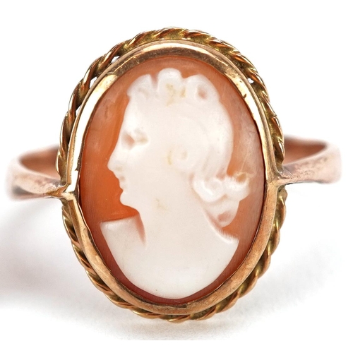 2334 - An unmarked gold cameo shell ring carved with a maiden head and pair of yellow metal cameo earrings,... 