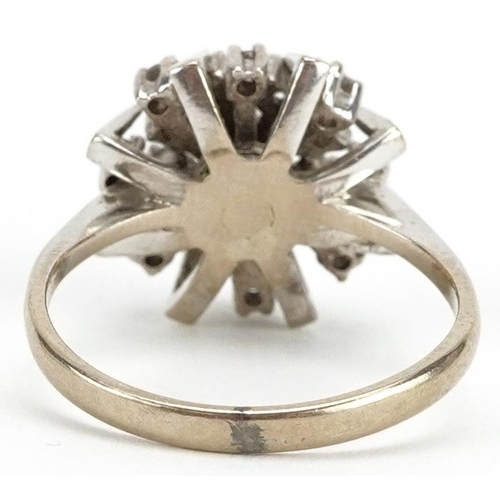 2003 - An 18ct white gold diamond starburst three tier cluster ring, size L, 4.7g.