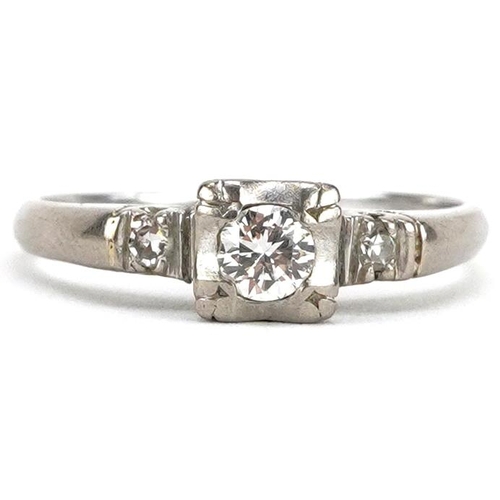 2009 - An Art Deco unmarked white gold diamond solitaire ring with diamond set shoulders, the central diamo... 