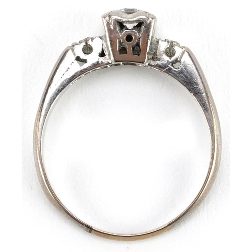 2009 - An Art Deco unmarked white gold diamond solitaire ring with diamond set shoulders, the central diamo... 