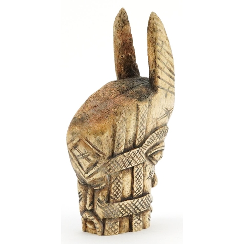 224 - An African carved bone horned figural bust, 20th century, 22cm high.