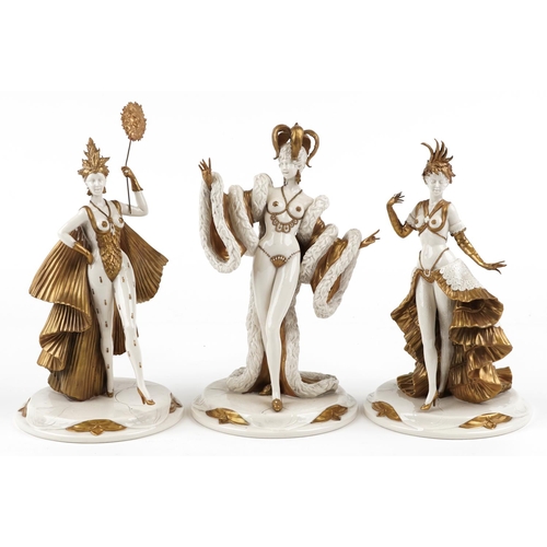 428 - Three partially gilt Capodimonte figurines of burlesque dancers, the largest 33cm high.