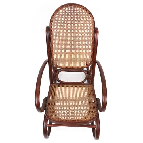 1049 - A mid 20th century bentwood rocking armchair with cane seat and back, possibly by Thonet, Austria, 1... 