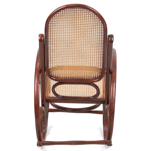 1049 - A mid 20th century bentwood rocking armchair with cane seat and back, possibly by Thonet, Austria, 1... 