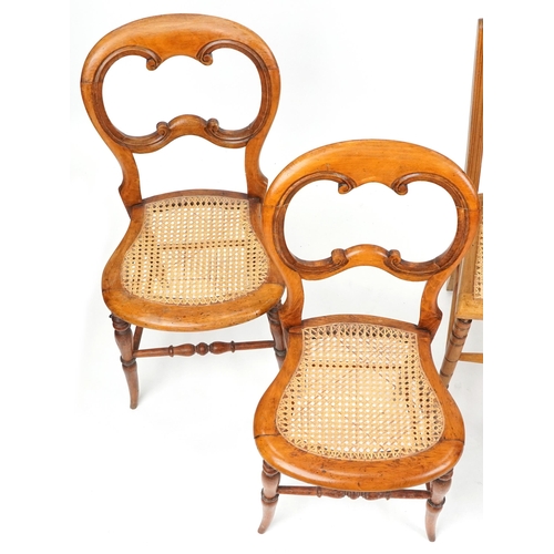 1050 - A pair of early 20th century beech framed bedroom chairs with cane seats together with three other c... 