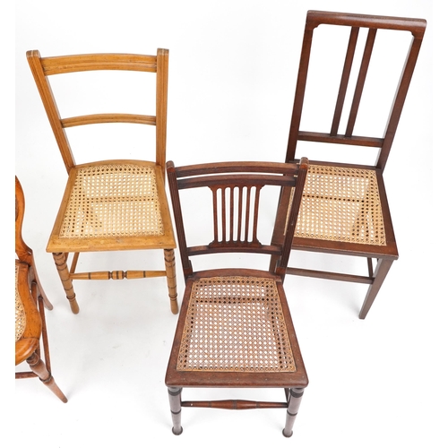 1050 - A pair of early 20th century beech framed bedroom chairs with cane seats together with three other c... 