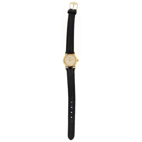 2571 - A Tissot 18ct gold cased ladies wristwatch with black leather strap, the dial 2cm in diameter, boxed... 