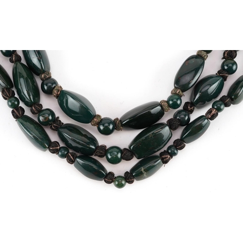 2540 - Two similar polished green hardstone necklaces, 59cm in length.