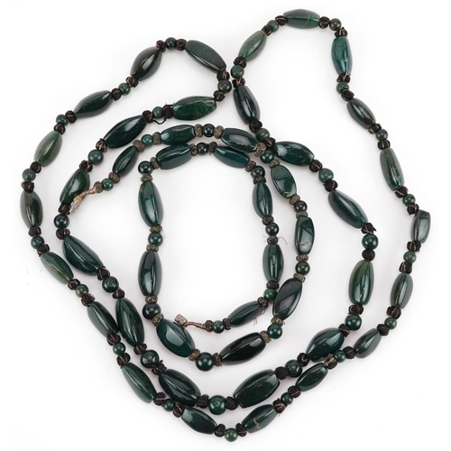 2540 - Two similar polished green hardstone necklaces, 59cm in length.