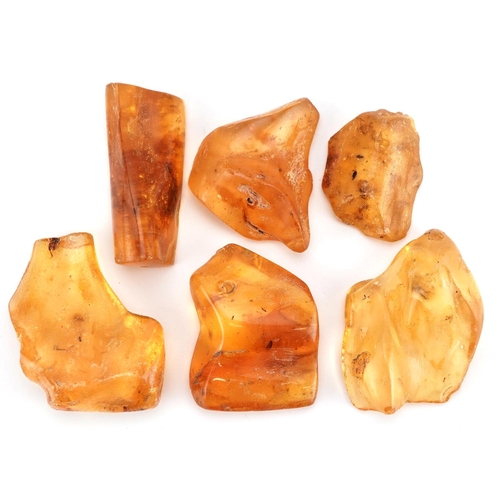 1274 - A group of six rough cut translucent amber shards, the largest 5cm in length